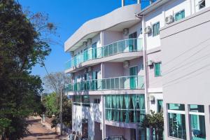 a building with balconies on the side of it at Hotel Ametista in Ametista do Sul