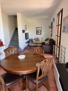 a living room with a wooden table and chairs at Casa Sole in Uzzano