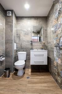 a bathroom with a toilet and a sink and a mirror at La Mansión in Lozenets +51 photos