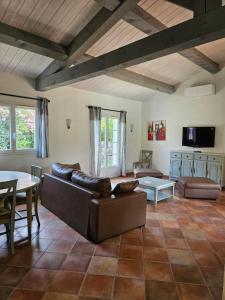 a living room with a couch and a table at Callian - Très belles Villas, 3 chambres et piscine privée in Callian