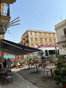 a patio with tables and chairs and a building at Marilyn Home in Palermo