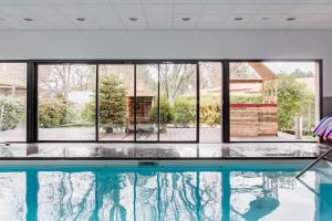 a swimming pool with a view of a large window at Gite Gauriaguet in Gauriaguet