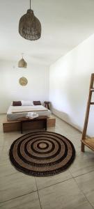 a room with a bed and a rug on the floor at Bons Aires in Atins