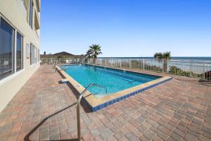 a swimming pool with the ocean in the background at Penthouse Condo with wrap around views of the ocean - SR802 in Edgewater