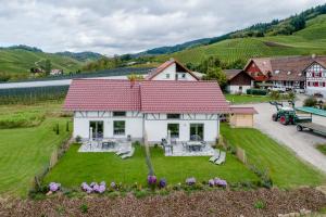 an aerial view of a white house with a red roof at Binzighof Ferienhäuser in Oberkirch