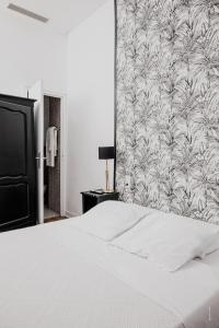 Postel nebo postele na pokoji v ubytování Hotel Moderne Et Pigeon