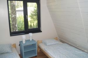 Letto o letti in una camera di Domek nad Jeziorem Kaszuby max 6 os
