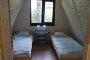 Letto o letti in una camera di Domek nad Jeziorem Kaszuby max 6 os