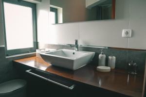 a bathroom with a sink and a toilet at Rauls Place in Madalena +20 photos