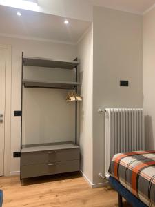 a bedroom with a bed and a dresser in a room at Casa Sajont in Antronapiana