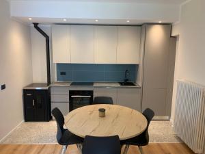 a kitchen with a table and chairs in a room at Casa Sajont in Antronapiana