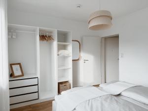 a white bedroom with a bed and a closet at Bohemian Suite - Detmold in Detmold