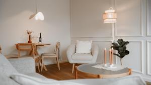 a living room with a chair and a table with candles at Bohemian Suite - Detmold in Detmold