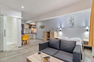 a living room with a couch and a kitchen at Budget Flats Leuven in Leuven