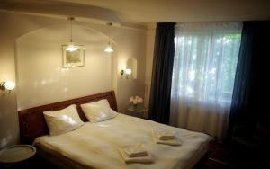 a bedroom with a bed with two towels on it at Private house 2km from old town in Riga