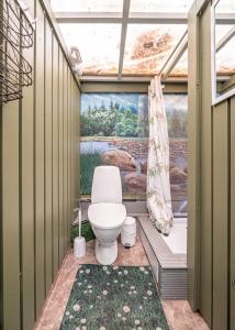 a bathroom with a toilet in a green house at City Center Garden Camping in Tallinn