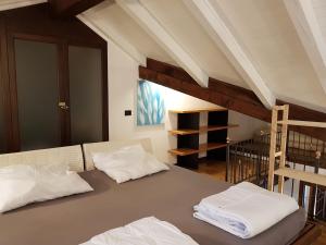 two white pillows sitting on a bed in a room at Residenza Ticino in Intra +20 photos