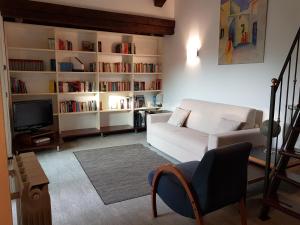 a living room with a white couch and book shelves at Residenza Ticino in Intra