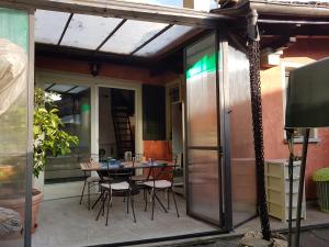 a patio with a table and chairs on it at Residenza Ticino in Intra