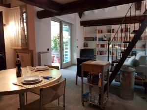 a living room with a table and chairs and a dining room at Residenza Ticino in Intra