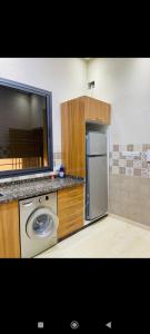 a kitchen with a refrigerator and a washing machine at Marrakech villa in Marrakech