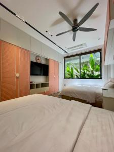 a bedroom with two beds and a ceiling fan at DELUXE VILLA 4 phòng ngủ 5 giường lớn in Hue