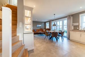 a kitchen and living room with a table and chairs at Hus in Luv in Greetsiel