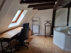 a office with a desk and a chair in a attic at Duplex Cité Plantagenêt - 2 Voyageurs - WIFI in Le Mans
