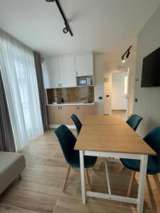 a kitchen and dining room with a wooden table and chairs at IL Pero - BED AND RELAX in Ateleta