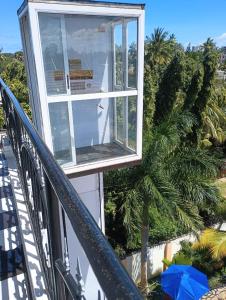 a window on a house with a sailboat in it at WISE HOTEL & apartment in Mtwapa