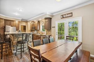 a kitchen with a wooden table and chairs at Red Bear Run in Beech Mountain
