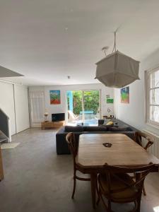 ein Wohnzimmer mit Sofa und Tisch in der Unterkunft Maison 300 m de la plage avec un bel extérieur in Gruissan