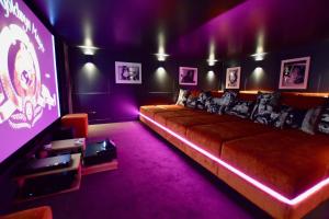 a living room with a couch and a tv at Chalet Valambrun - unashamedly luxurious Alpine living in Les Gets