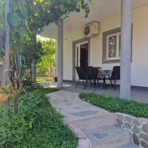 a patio with chairs and a table in a house at Apartmani Vlahović in Sutomore