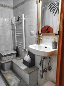 a bathroom with a sink and a mirror on the wall at Ospite al centro in Molfetta