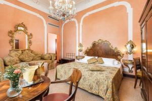 a bedroom with a bed and a couch and a table at Hotel San Mois&egrave; in Venice