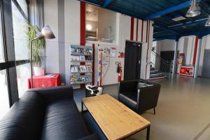 a living room with a couch and a table at Auberge de Jeunesse de Mulhouse in Mulhouse