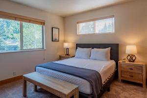 a bedroom with a large bed and two windows at Bridgepoint Condo 08 in Ketchum