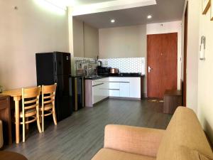 a kitchen with a couch and a table in a room at Windy homestayPR in Kinh Dinh