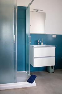 a bathroom with a shower and a sink and a mirror at Villa del Lupo in Santa Maria la Palma