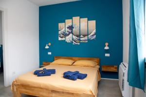 a blue bedroom with a bed with blue walls at Villa del Lupo in Santa Maria la Palma