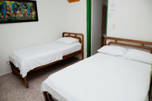 Letto o letti in una camera di Hotel Casa Verde Guatapé