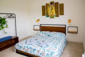 a bedroom with a bed with blue and white sheets at Villa del Lupo in Santa Maria la Palma