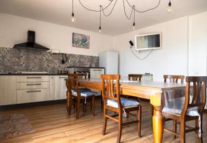 a kitchen with a large wooden table and chairs at Casalebellavista in Tarquinia