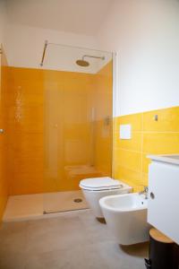 a bathroom with a toilet and a sink and a shower at Villa del Lupo in Santa Maria la Palma