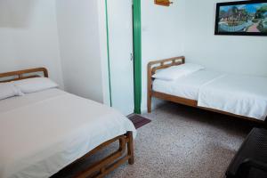 Letto o letti in una camera di Hotel Casa Verde Guatapé