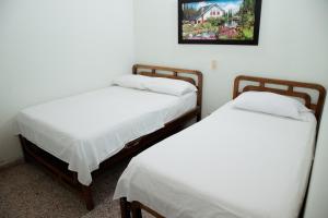 Letto o letti in una camera di Hotel Casa Verde Guatapé