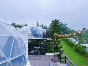 a garden with domes and tents with lights at ภูเก็บตะวัน in Khao Kho