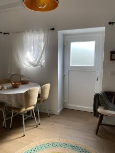 a dining room with a table and chairs and a window at Casa do Montinho in Caminha +6 photos