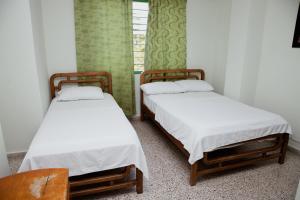 Letto o letti in una camera di Hotel Casa Verde Guatapé
